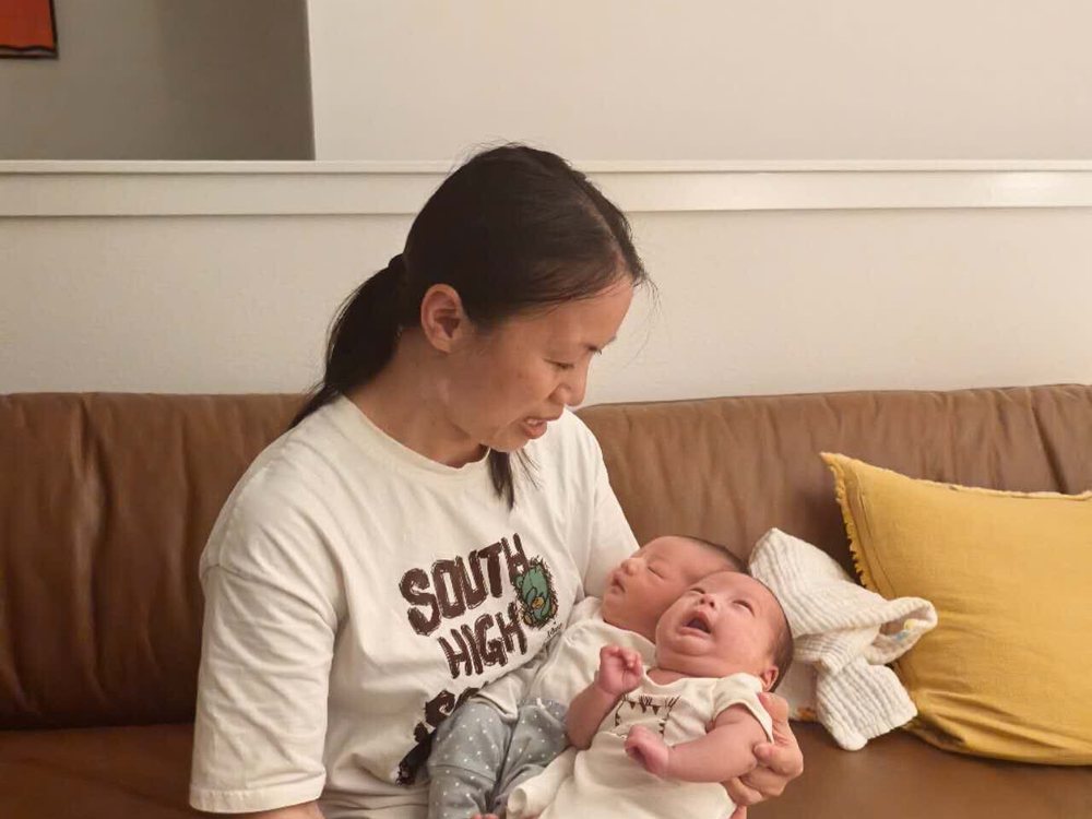 Rainy soothing a newborn during a feed