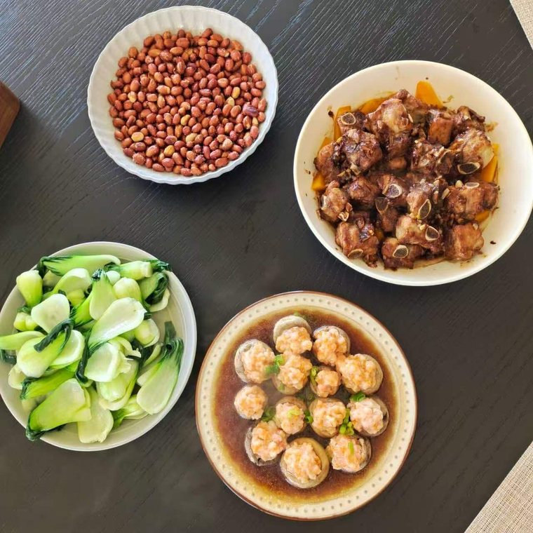 Confinement meal: braised pork ribs, bok choy, stuffed mushrooms and peanuts